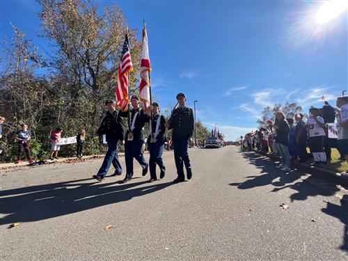 color guard marching in parade at Mill Creek Elementary